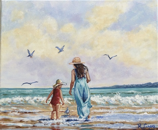 Woman and child on beach with seagulls, cloudy sky