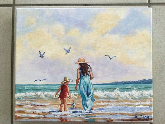 Woman and child on beach with seagulls, cloudy sky