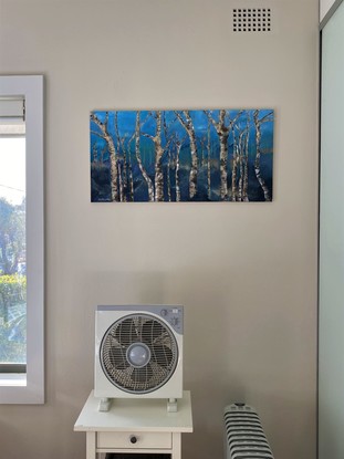 Trees in the bush of Australia. Blue background and trees of browns and whites.