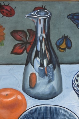 Bowls of berries, an apple, lemons, mandarin and silver oil jug on white tablecloth 
