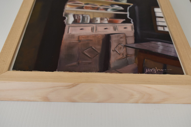 An old wooden kitchen cupboard in a corner beside a window that is bringing a ray of light casting shadows in the room.