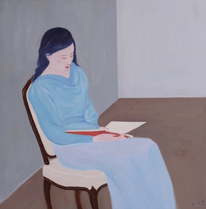 A woman is reading  a book