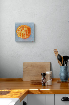 A partly peeled mandarin on a blue background. 