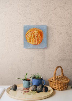 A partly peeled mandarin on a blue background. 