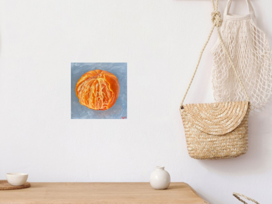 A partly peeled mandarin on a blue background. 