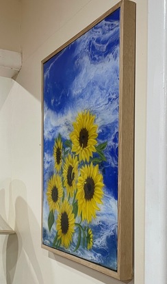 Sunflowers on a sky blue background in a floating Tassie oak frame.