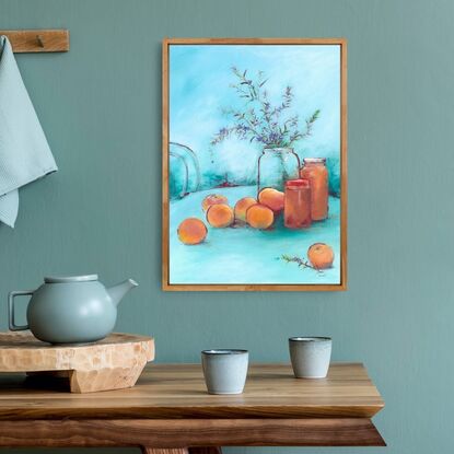 Modern simple style still life of apricots with rosemary sprigs, jam jars on outdoor table with turquoise blue sky.