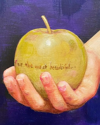 Youth's hand holding a gold apple inscribed with "for the most beautiful."