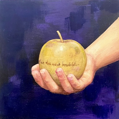 Youth's hand holding a gold apple inscribed with "for the most beautiful."