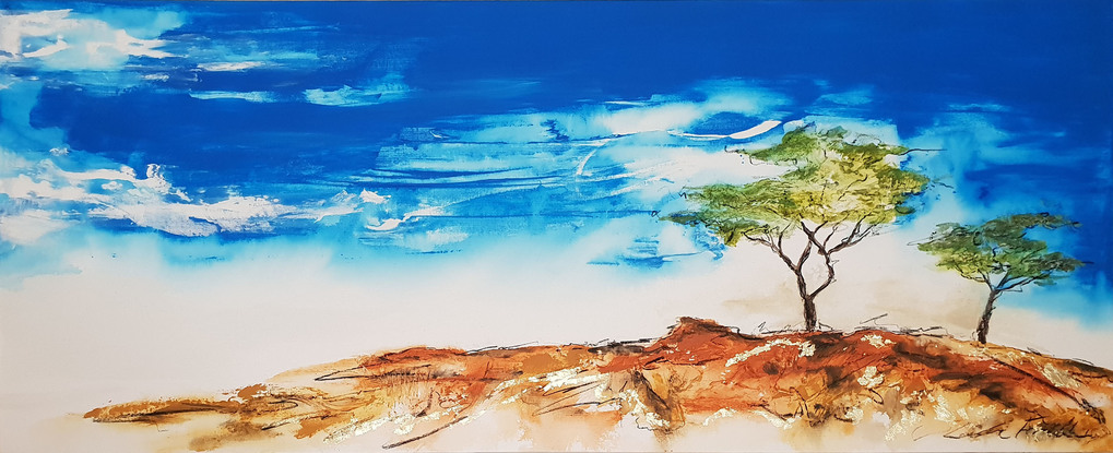 a big landscape of a blue sky, trees and read earth of the Australian outback with gold leaf.