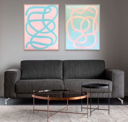 Two large matching paintings with pink and turquoise squiggly lines.