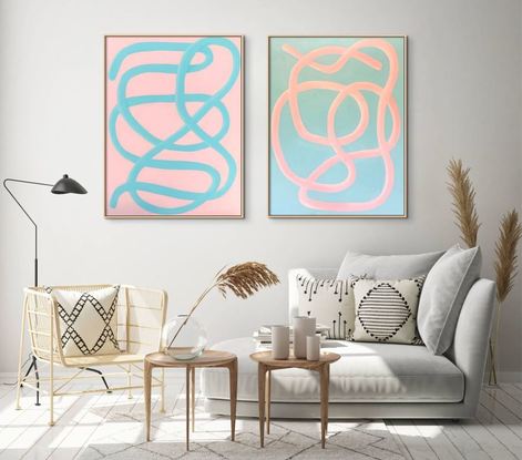 Two large matching paintings with pink and turquoise squiggly lines.