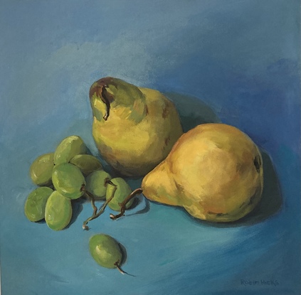 Yellow and green pears green grapes against a blue background 