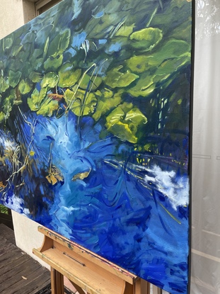 This is a large horizontal oil painting on canvas  measuring 122x91 cm   (4x3ft)  lily pads in a pond.    Along the horizontal middle line the pads are bright green,  before  receding into the background.  

Ultramarine and cerulean blue water reflect the colour of the sky and white clouds into the foreground.   In the bottom left corner there is tangled of dying stem and "drowning leaves". 

 Rather than a romantic depiction of lily pads this painting is bold and colourful,  containing all of the life cycles of the lily pads,  from flowers to dying .