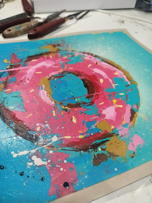 pink iced donut painted on an aqua gradient background in a street art/graffiti style