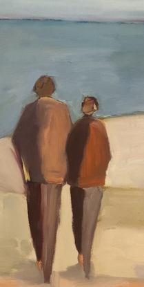 Two people walking together on the beach