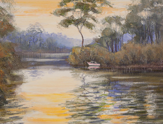 River scene with boat, sunset and reflections.