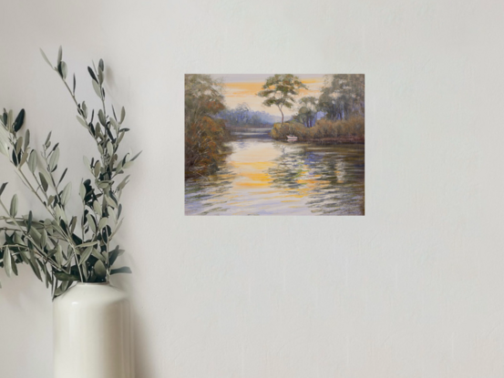 River scene with boat, sunset and reflections.