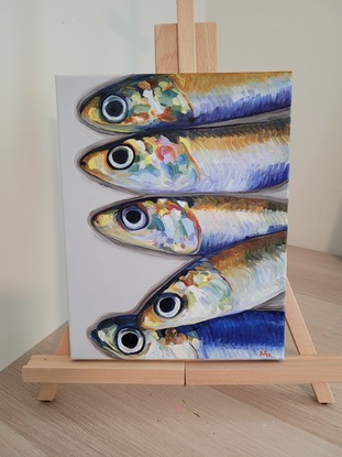 A row of rainbow anchovy heads.