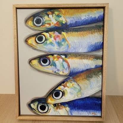 A row of rainbow anchovy heads.