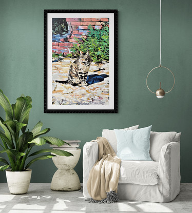 A portrait orientation canvas depicting a lone tabby cat standing  amongst the Roman ruins, in a sturdy black floating frame.