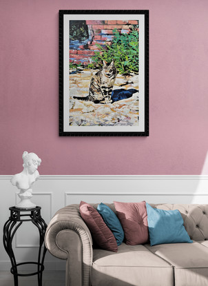 A portrait orientation canvas depicting a lone tabby cat standing  amongst the Roman ruins, in a sturdy black floating frame.