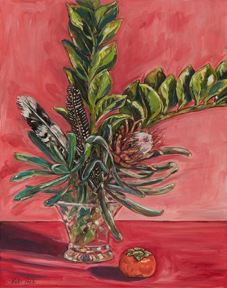 Still life with feathers in crystal vase and bold pink background