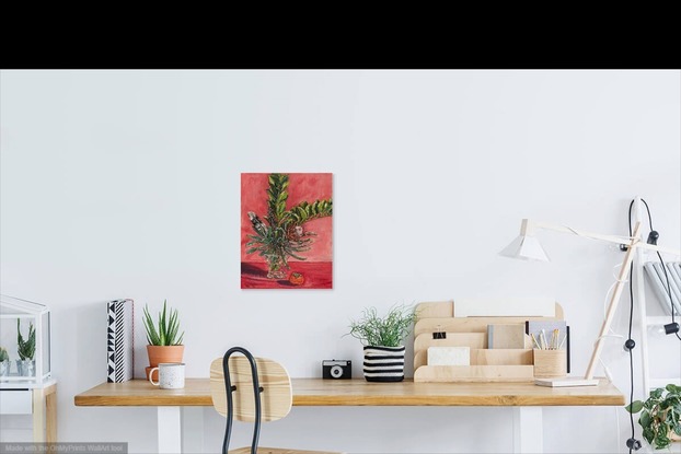 Still life with feathers in crystal vase and bold pink background