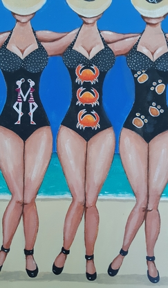 Twelve wonen on beach wearing bathing suits with star sign emblems