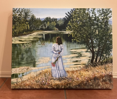 Woman in long dress standing on river bank looking at river reflections and ducks