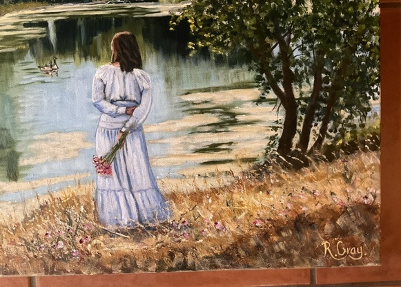 Woman in long dress standing on river bank looking at river reflections and ducks