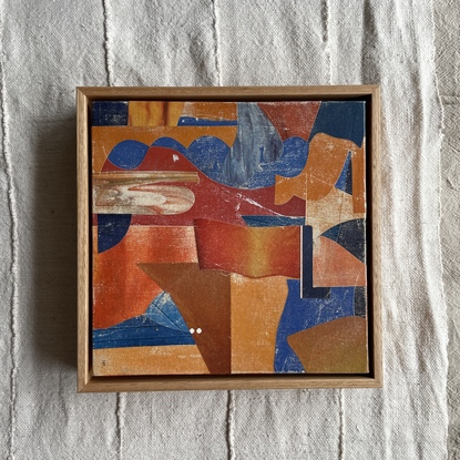 Square canvas board with paper collage in orange and blue blocks of colour in abstract shapes. 