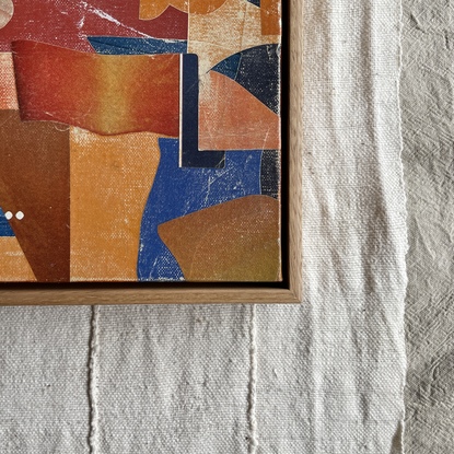 Square canvas board with paper collage in orange and blue blocks of colour in abstract shapes. 