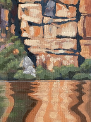 A large cliffs and water with reflections.