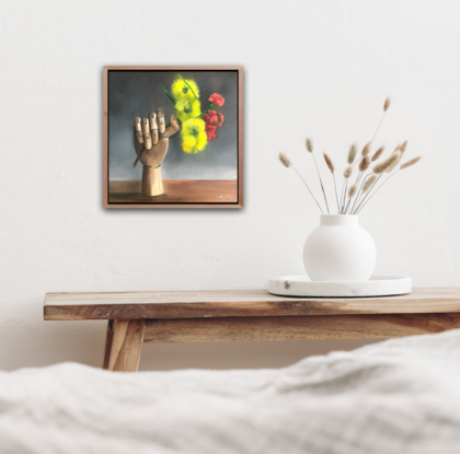 Artist wooden hand holding an Illyarrie red cap gum blossom.