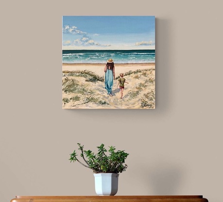 Woman and child walking through dunes to beach