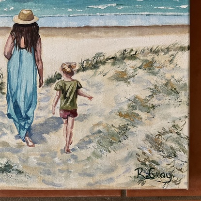 Woman and child walking through dunes to beach