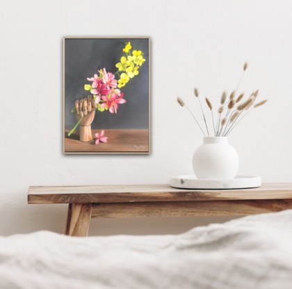 Frangipani and golden shower blossom with an artist's wooden hand. 