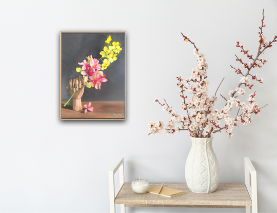 Frangipani and golden shower blossom with an artist's wooden hand. 