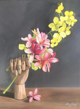 Frangipani and golden shower blossom with an artist's wooden hand. 