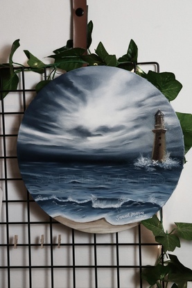 A storm is forming at the beach in the distance of the horizon. Waves are beginning  to form and crash into the lighthouse which is placed to the right of the painting. 