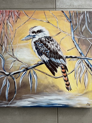 Kookaburra sitting on a branch of eucalyptus tree. 