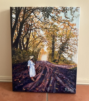 Autumn scene with woman walking along road 