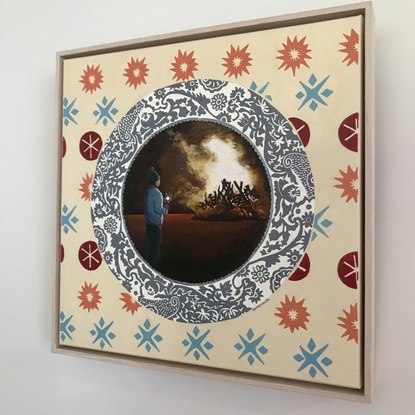 Grey plate on peach and orange wallpaper depicting a child watching a bonfire on fire cracker night