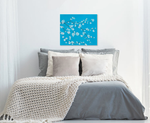 A textured painting of a branch of white blossom on a turquoise blue background.