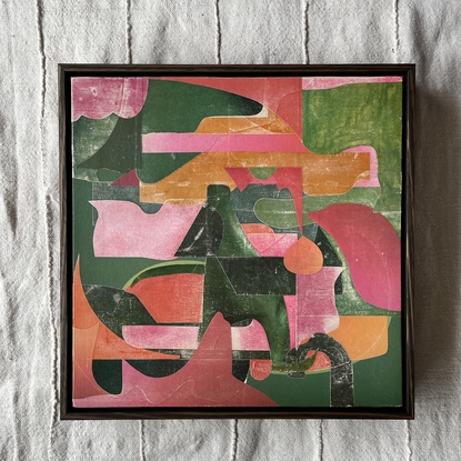 Square canvas board with paper collage in pink and green blocks of colour in abstract shapes. 