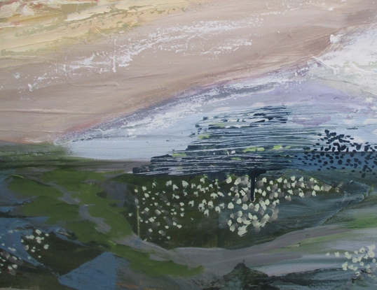 Colourful stacked rocks provide a fence to the sweeping beach view as it curves in the distance. Above the colourful sea is a stormy sky.