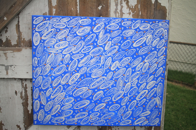 Deep blue background with spirals depicting shells and small dots around 