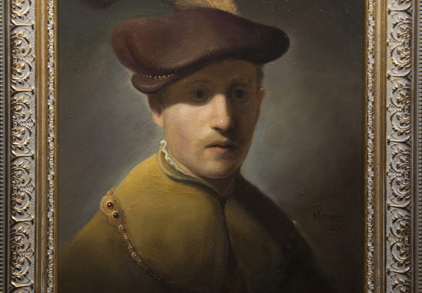 Young man with gold chain and plumed hat.