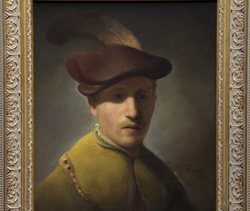 Young man with gold chain and plumed hat.